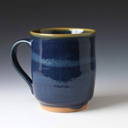 Hand-thrown ceramic mug with a textured surface and a deep blue glaze